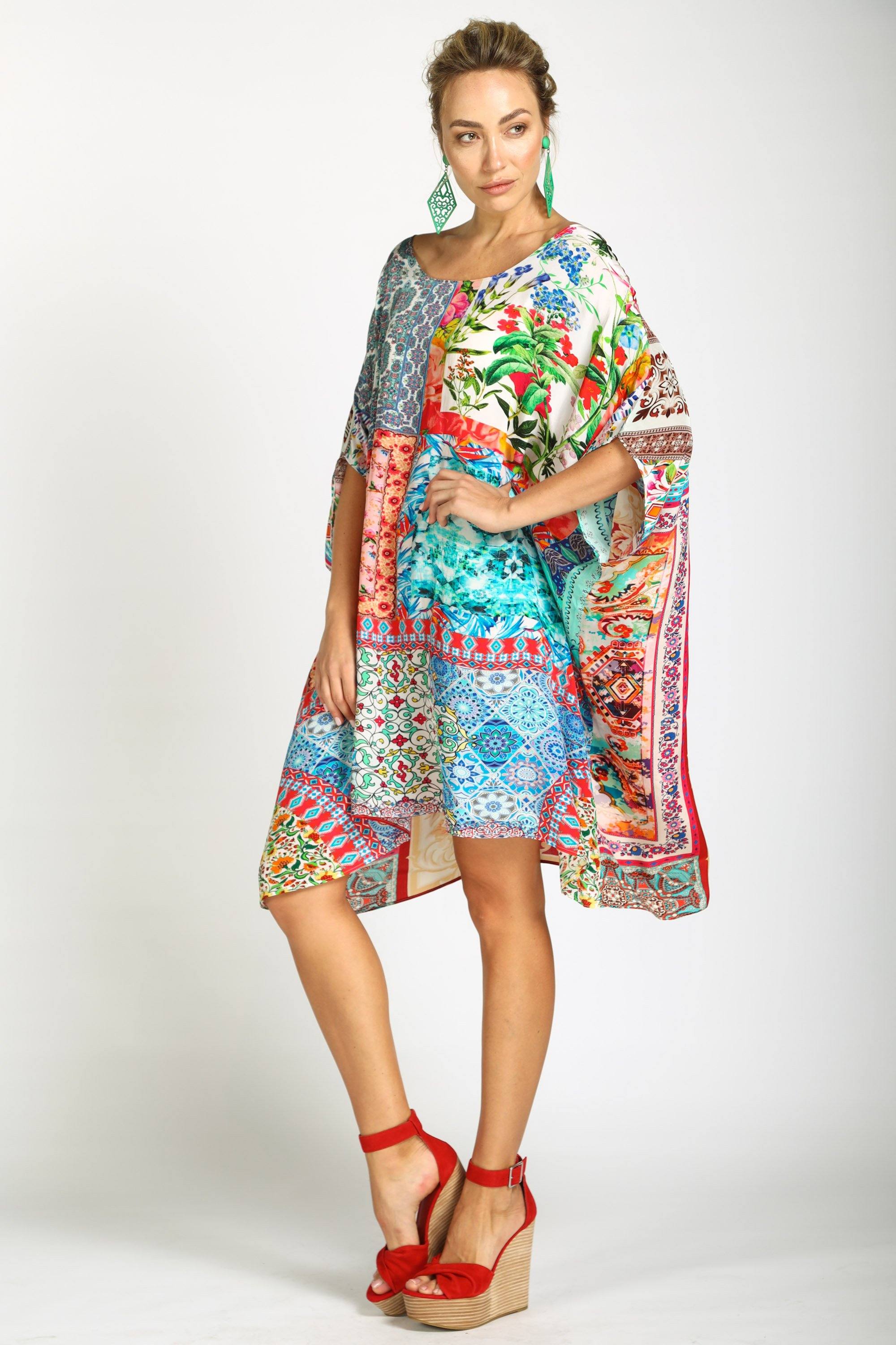 Side View Short Box Kaftan dress in the bold Damascus patchwork print. This kaftan is styled with a one-shoulder neckline and has a handkerchief hem, perfect for resort or festival wear.