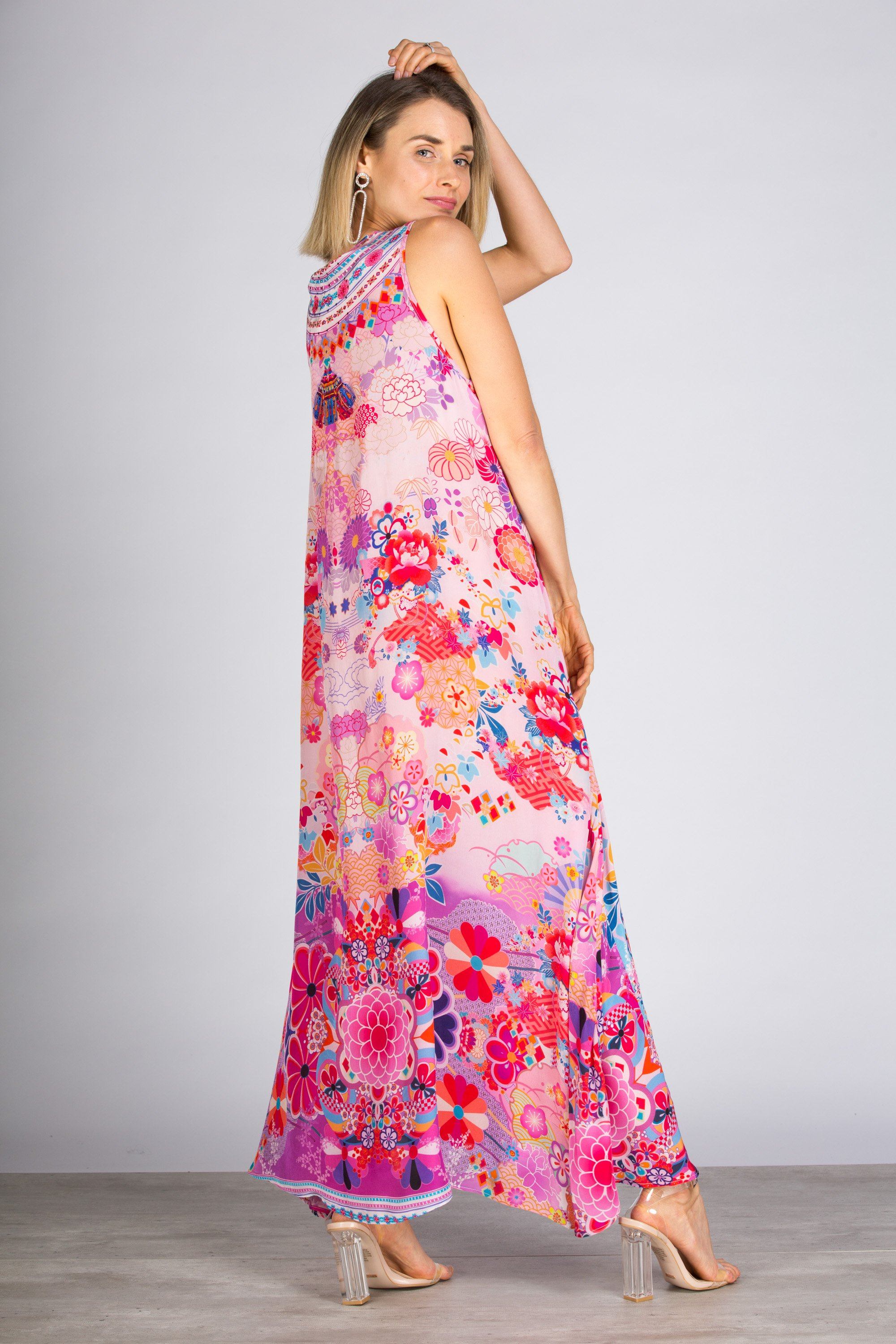 Side angle Model posing in the Bondi Resortwear Cherry Blossom Flowing Maxi Dress showcasing its soft feminine drape