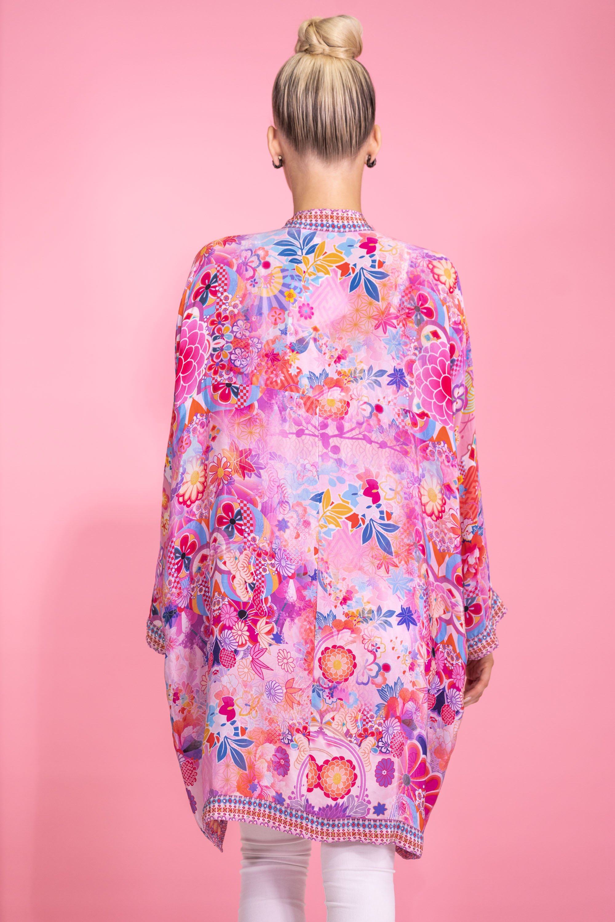 Back of TheSwankStore (now Bondi) floral kimono cardigan. This flowing, colorful cover-up shows the complete back pattern of mixed flowers and leaves in various bright hues, emphasizing its relaxed fit.