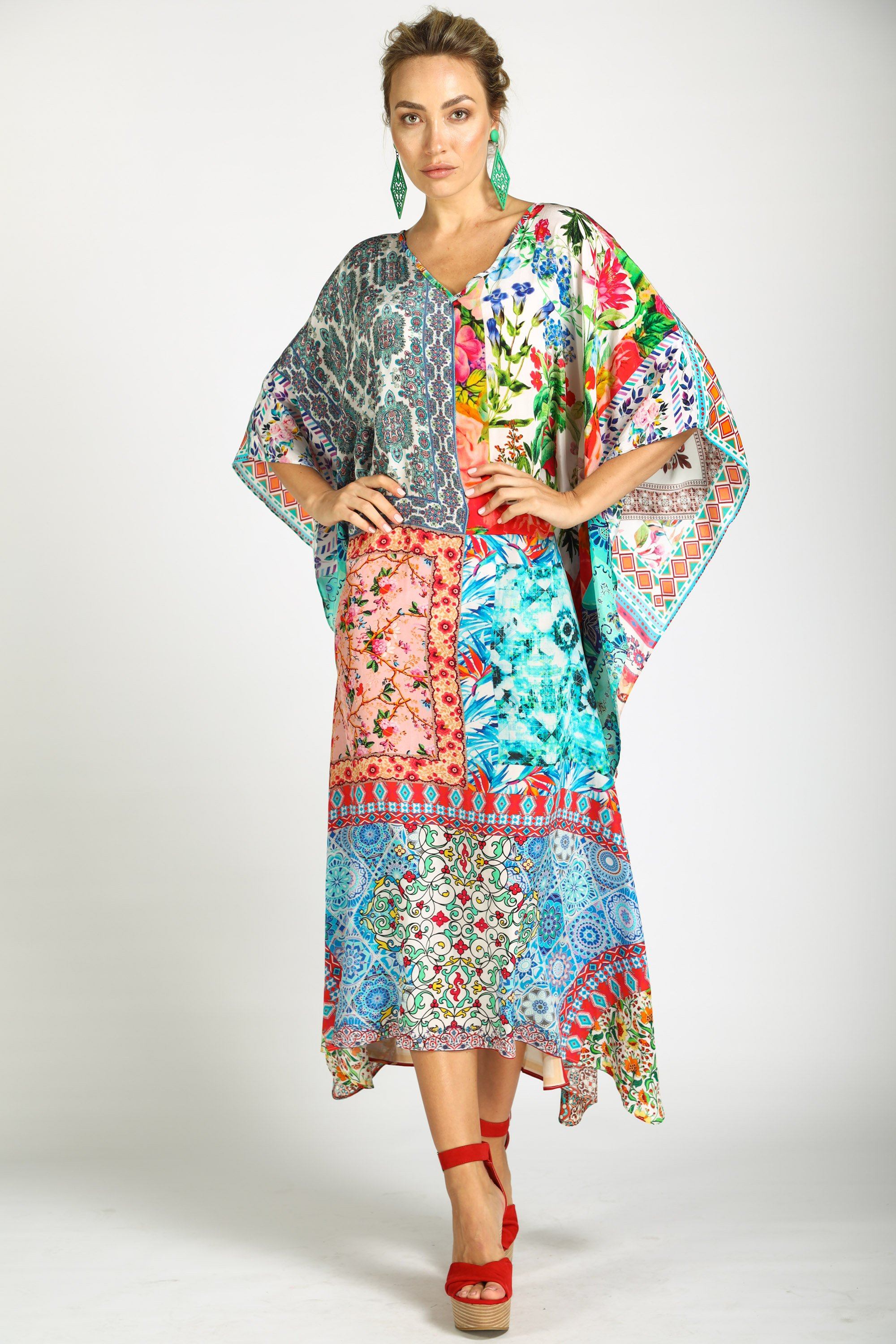 Front view Long, flowing kaftan dress in a bright floral print with pink, orange, yellow, and blue colors.
